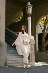 Woman posing in a white dress