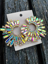 Studded earrings on a wooden background
