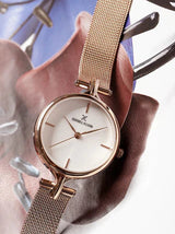 Women's gold watch with white dial.